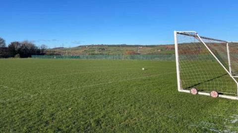 An empty football pitch with a goal