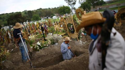 Cemetery workers dig new graves at the Xico cemetery on the outskirts of Mexico City