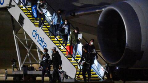 Australian Open players disembark a flight