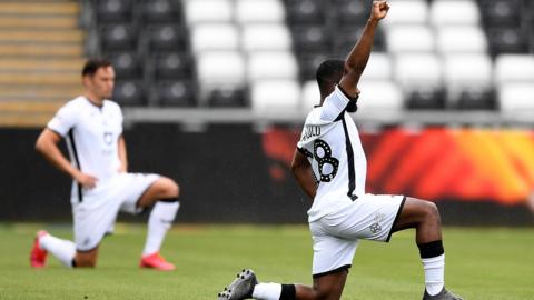 Swansea players take the knee before a game