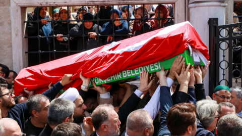People carry the coffin of a victim of a school shooting during the funeral prayers at a mosque in Kahramanmaras, Turkey