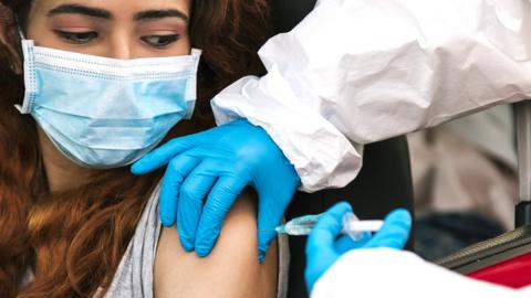 Woman receiving vaccination