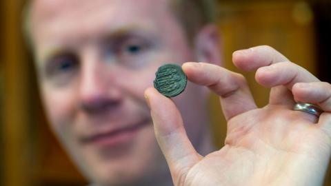 Prof Rory Naismith with Byzentine coin