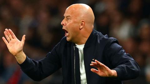 Arne Slot in an animated touchline pose during Liverpool's defeat by Paris St-Germain