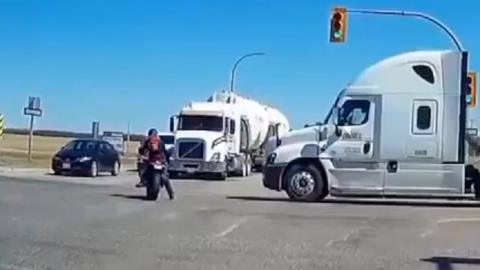 A truck driver in Canada was ticketed for distracted driving after colliding with a motorcyclist