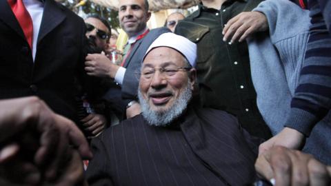 Muslim cleric Yusuf al-Qaradawi is welcomed by a crowd in Cairo's Tahrir Square on 18 February 2011
