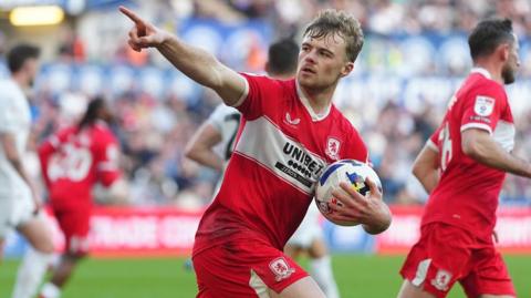 Tommy Conway points to the Middlesbrough fans after scoring his penalty at Swansea