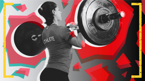 A woman lifts weights at a Cross Fit class