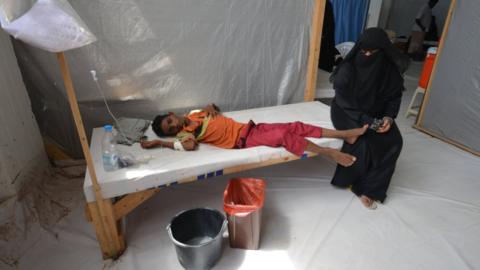 A woman sits next to her son who is infected with cholera at a hospital in the Red Sea port city of Hodeidah, Yemen, May 14, 2017.