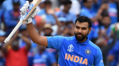 India opener Rohit Sharma raises his bat after hitting a century