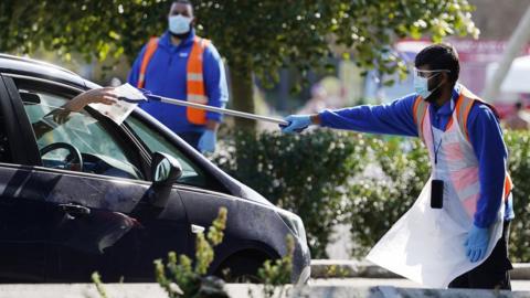 Members of the staff attend to motorist at a Covid-19 testing centre in Central London, Britain, 12 September 2020.