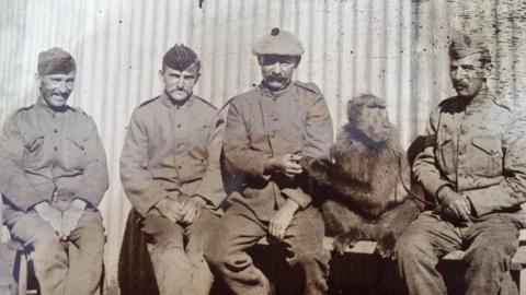 Soldiers with a baboon