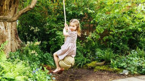 Princess Charlotte on a swing at the Chelsea Flower Show