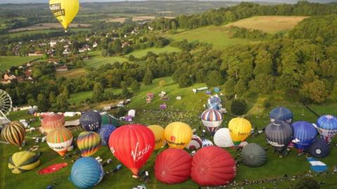 Hot air balloons are inflated during the mass ascent at the Bristol International Balloon Fiesta 2023.