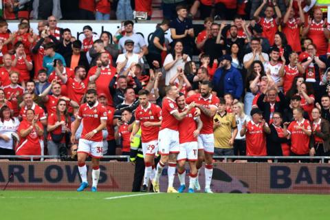 Wrexham players celebrate in front of fans at the Racecourse