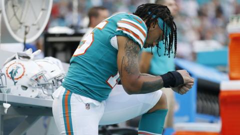 Miami Dolphins player Albert Wilson kneels during the US national anthem before an NFL game