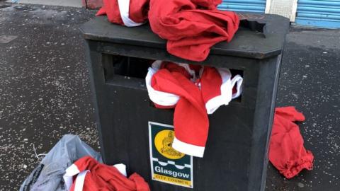 Santa costumes in bins