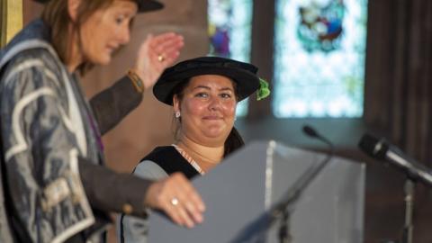 Joanne Telford gets her alumnus of the year award from the university's vice-chancellor