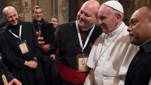 'Missionaries of Mercy' pose for a selfie with the Pope