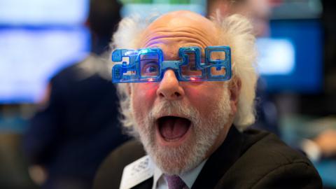 A trader works on the floor at the closing bell of the Dow Industrial Average at the New York Stock Exchange on December 29, 2017 in New York.