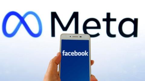 Facebook logo on a mobile with Meta logo in background