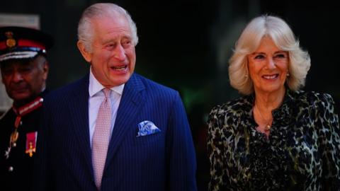 The King and Queen smile as they arrive at the hospital in central London