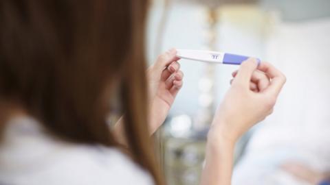 Girl holding pregnancy test