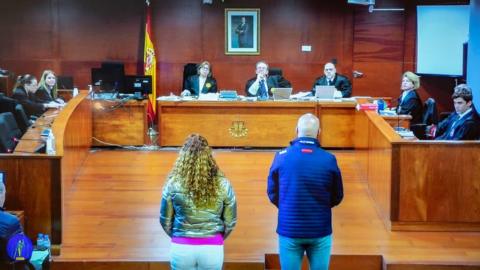 The two defendants stand before the court during their trial