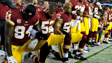 Washington Redskins players kneel during the national anthem before Sunday’s game at FedEx Field