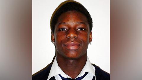 Kiyan Prince in school uniform, smiling for the photo
