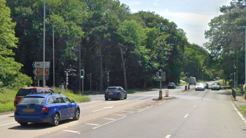 Google street view of A60 with cars driving along the road