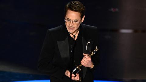 US actor Robert Downey Jr. accepts the award for Best Actor in a Supporting Role for "Oppenheimer" onstage during the 96th Annual Academy Awards at the Dolby Theatre in Hollywood, California on March 10, 2024.