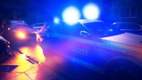 German police cars on the road at night