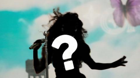 Silhouette of singer with question mark. 