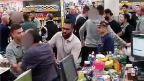 Shoppers fighting in supermarket