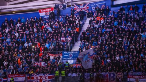 Rangers fans at the Estadio do Dragao, with a number of flags visible among the crowd