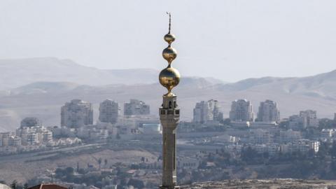 A general view of the mosque of the east Jerusalem neighbourhood of Issawiya and the Israeli West Bank settlement of Maale Adumim in the background, 19 November 2019