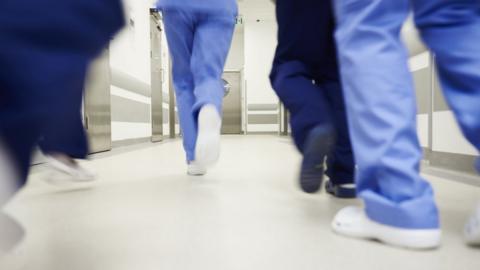 Feet running along a hospital corrdior