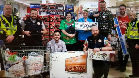 Tesco staff and police officers with gifts