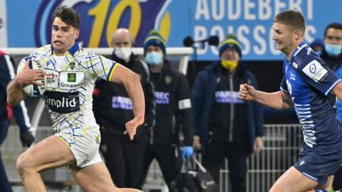 Clermont's Damian Penaud runs with the ball, chased by a Sale player