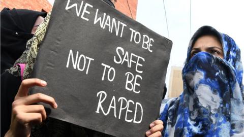 A demonstrator holds a placard during a protest calling for justice following the recent rape and murder case of an eight-year-old girl in Indian-administered Kashmir.