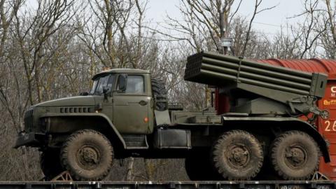 A Russian military vehicle is loaded onto a train