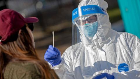 A test being conducted by a worker in PPE