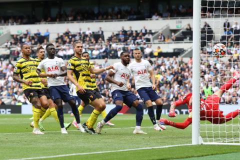 Son Heung-min's free-kick for Tottenham evades the dive of Watford goalkeeper Daniel Bachmann.