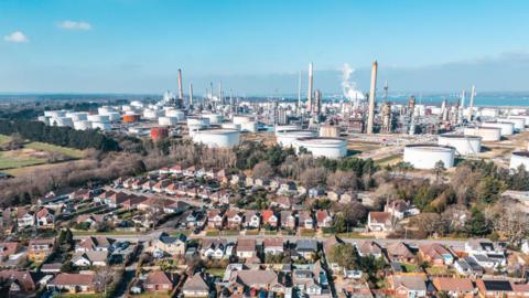 Aerial view of Fawley oil refinery and residential houses in Southampton.