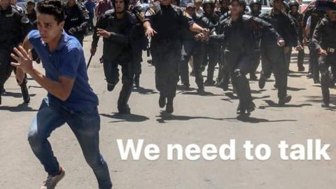 An activist running away from police - with 'We need to talk' superimposed