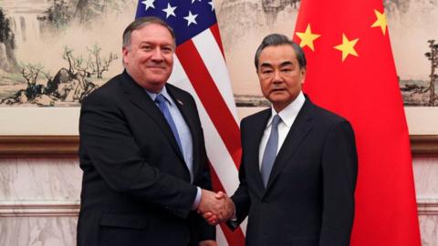 U.S. Secretary of State Mike Pompeo shakes hands with Chinese Foreign Minister Wang Yi as they pose for a photograph at the Diaoyutai State Guesthouse in Beijing