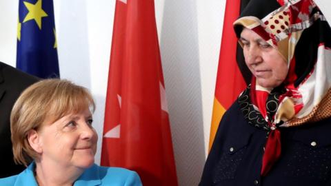 German Chancellor Angela Merkel (L) and Mevluede Genc (R), surviving relative of the Solingen arson attack, during the commemoration ceremonies