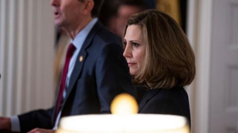 Pam Northam, wife of Virginia Governor Ralph Northam, listens as he speaks to reporters