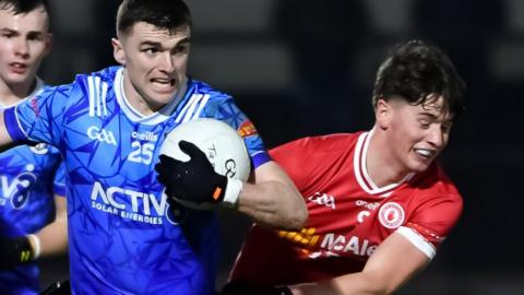 Monaghan's Micheal McCarville is tackled by Aodhan Donaghy of Tyrone